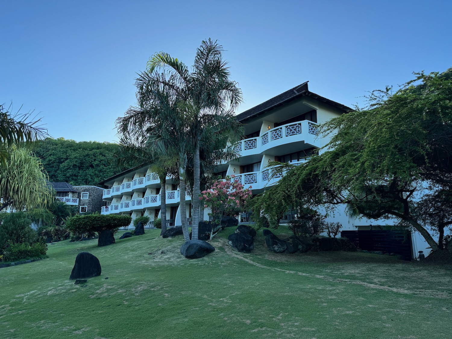 a building with trees and grass