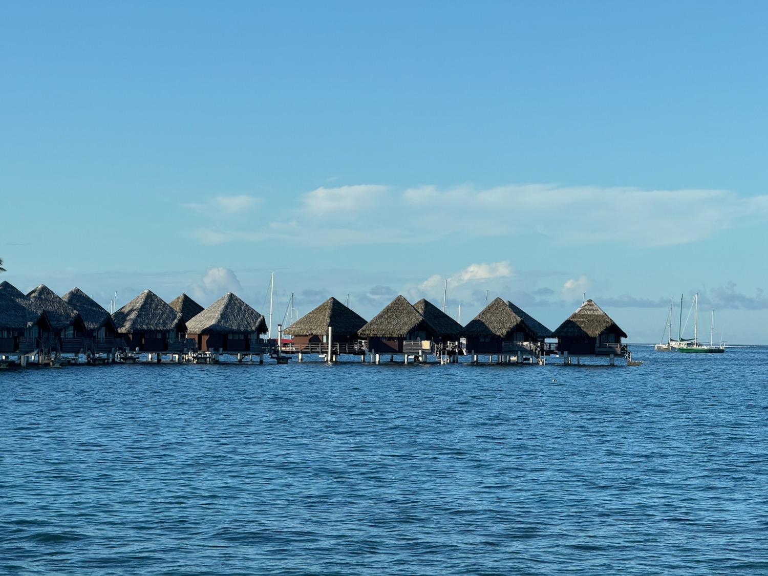 a group of houses on stilts in the water