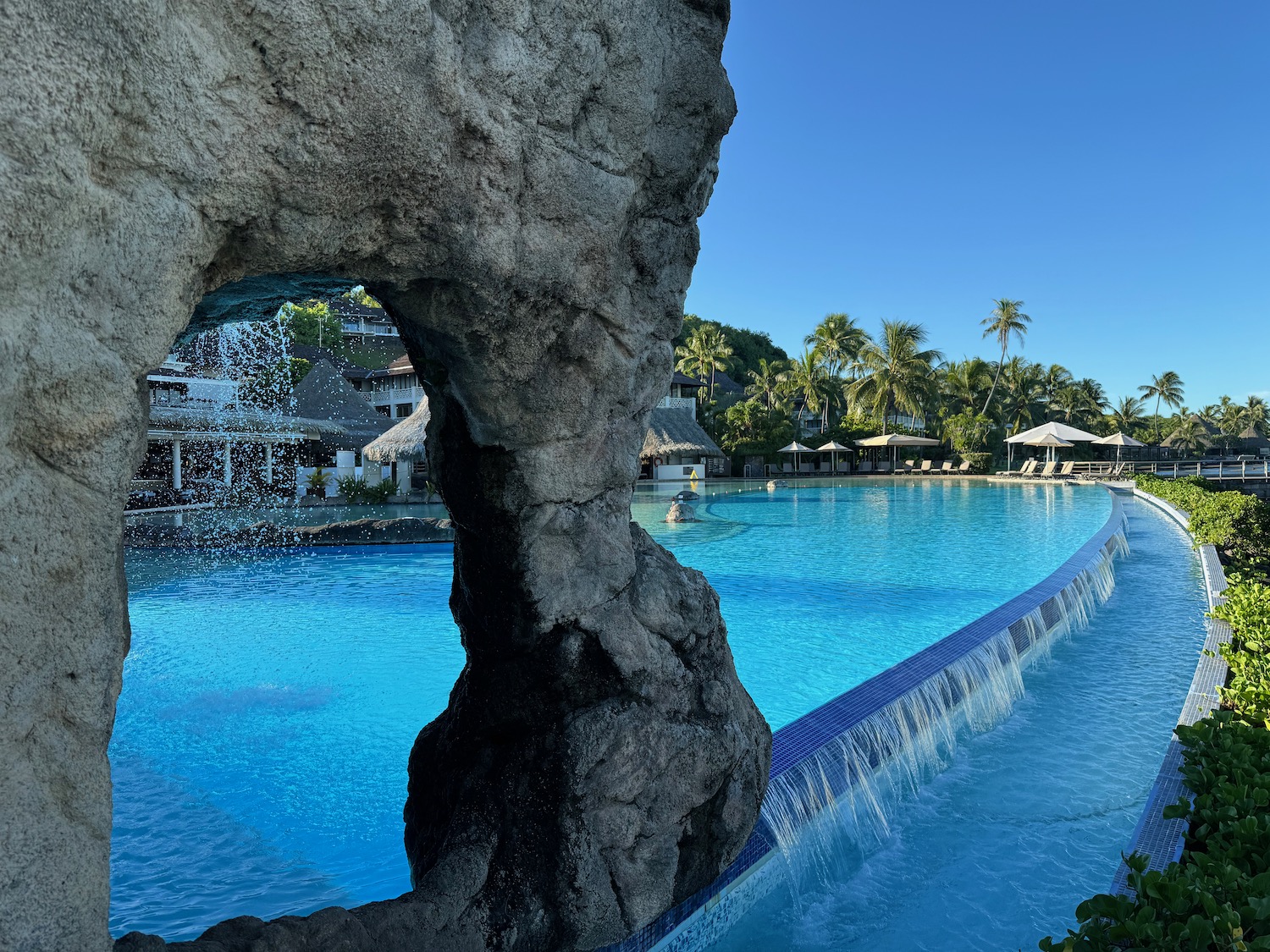 a large rock formation in a pool