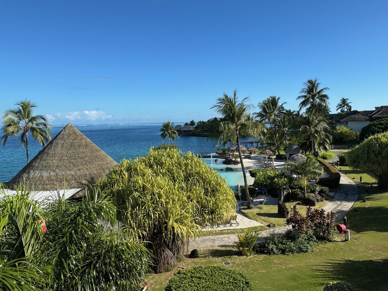 a view of a resort with a body of water and trees