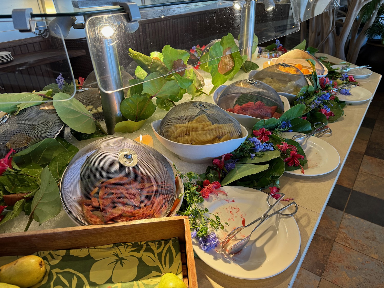 a buffet with plates and fruit