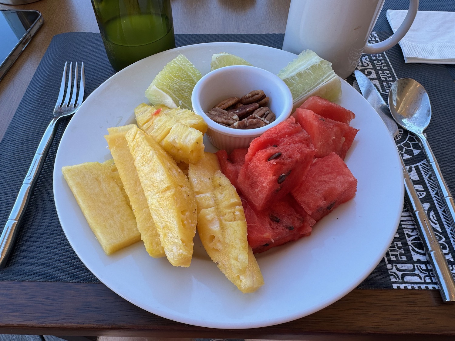 a plate of fruit and pecans