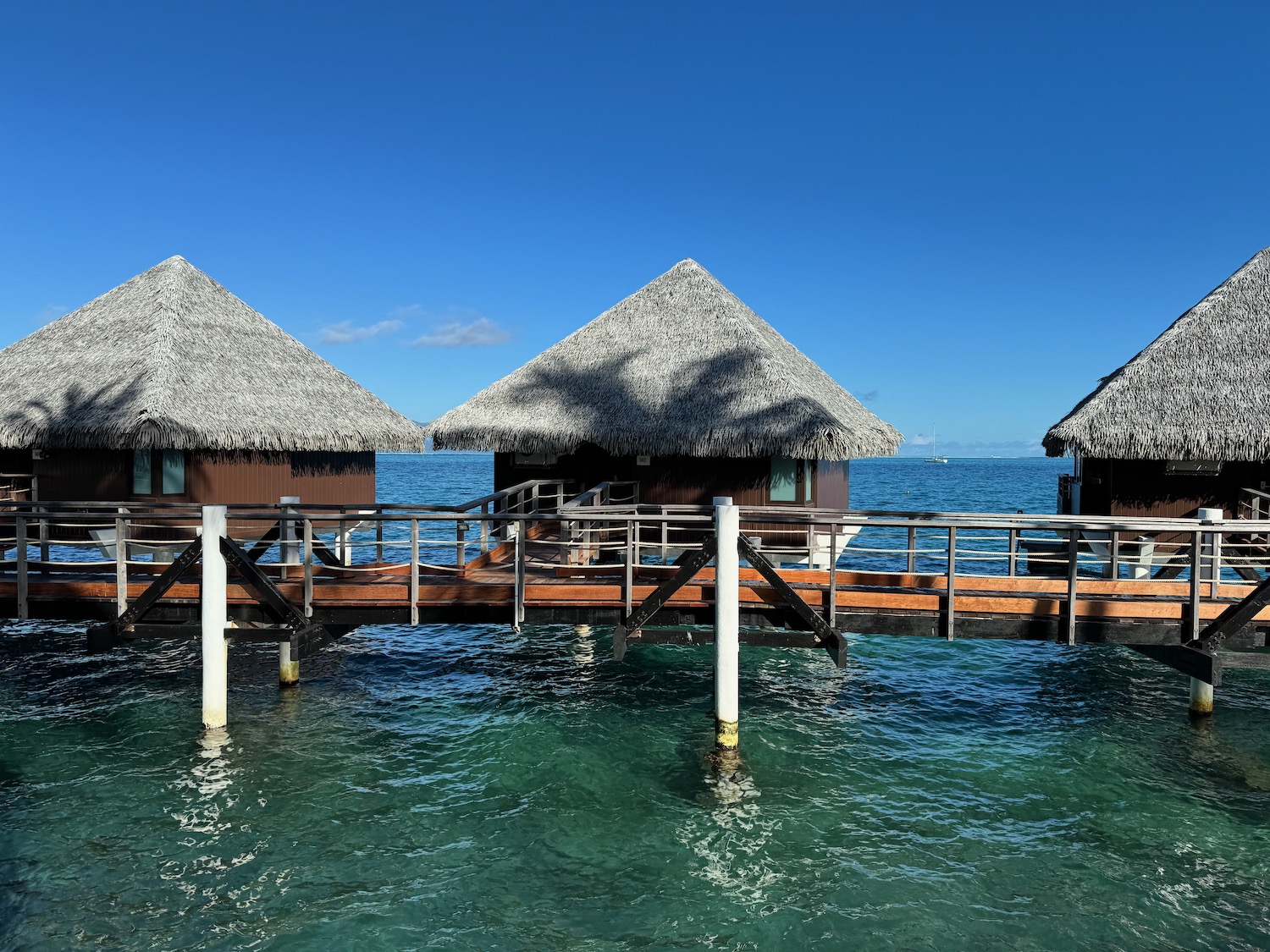 a group of huts on a dock over water