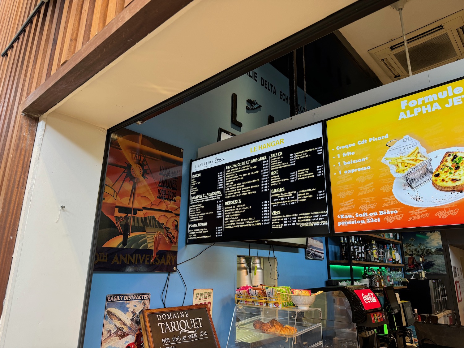 a screen with menus and drinks in a glass case