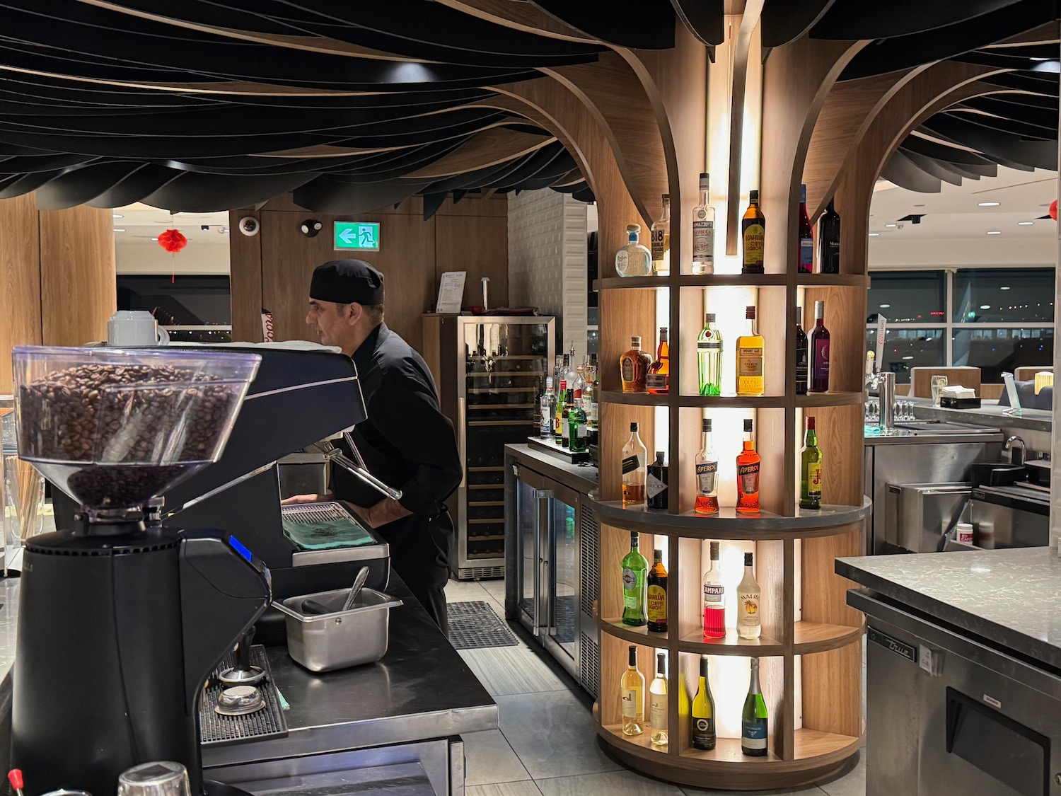 a man standing behind a counter in a restaurant