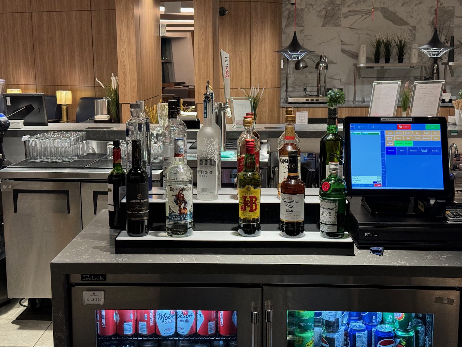 a bar with bottles of alcohol and a computer