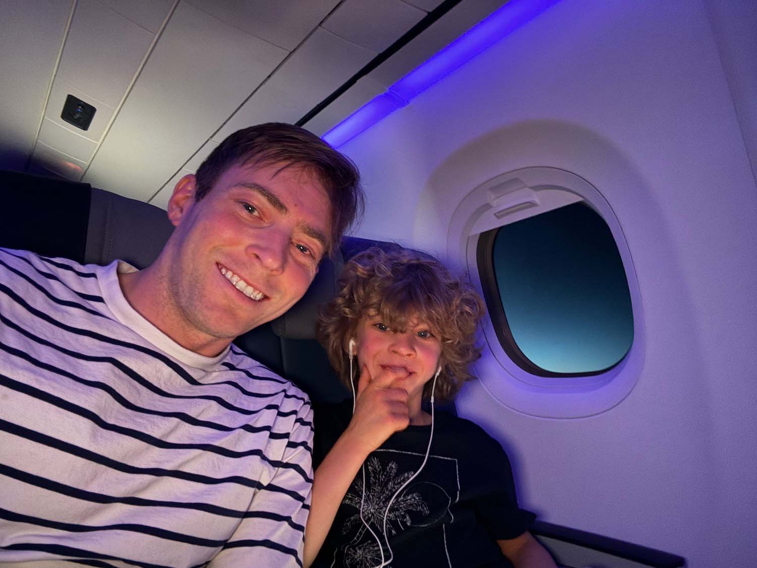 a man and child sitting in an airplane