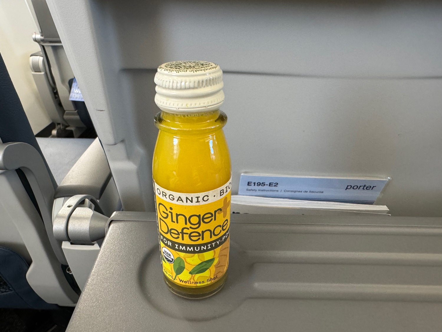 a bottle of ginger defence on a plane