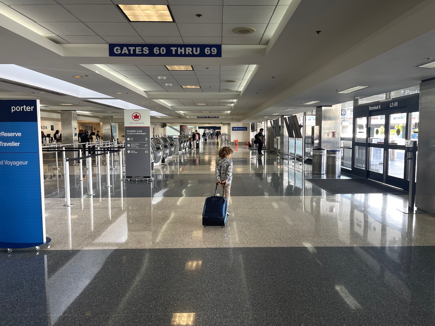 a child with a suitcase in an airport