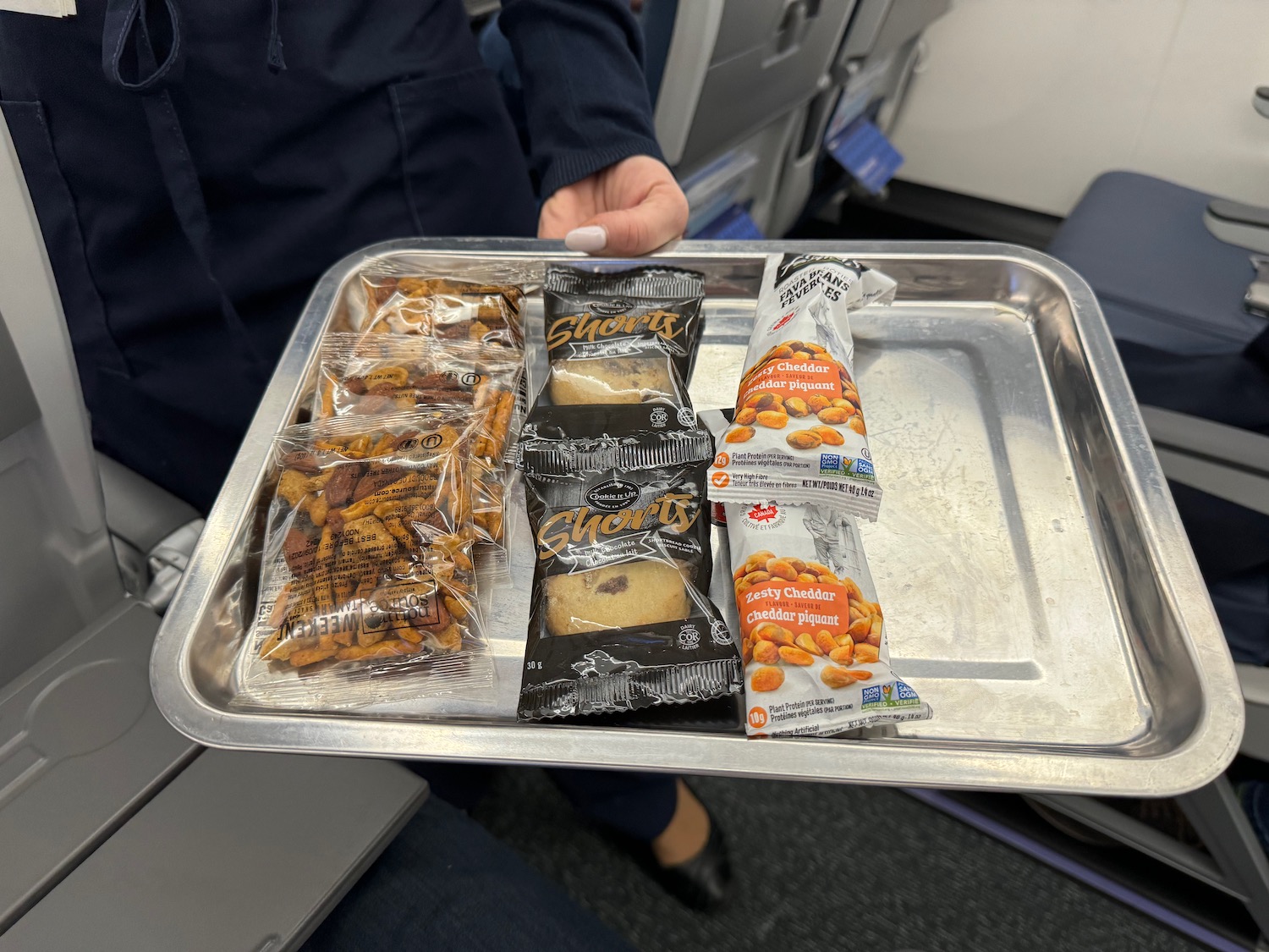 a tray of snacks on an airplane