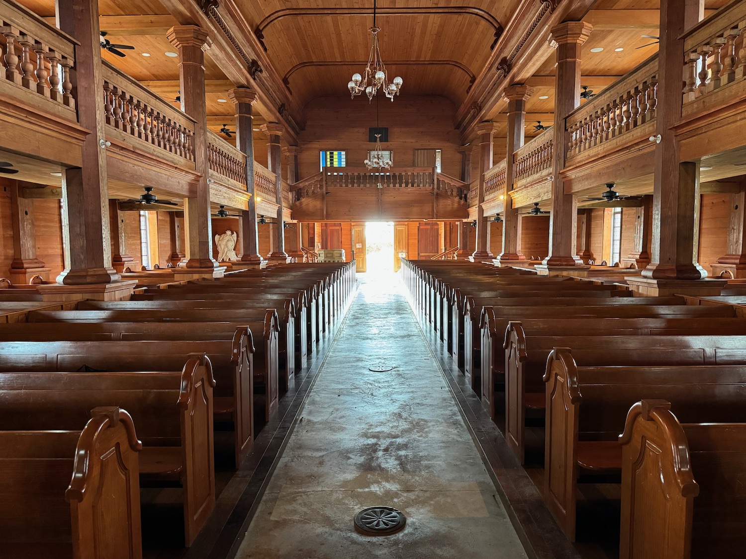 inside a church with wooden benches