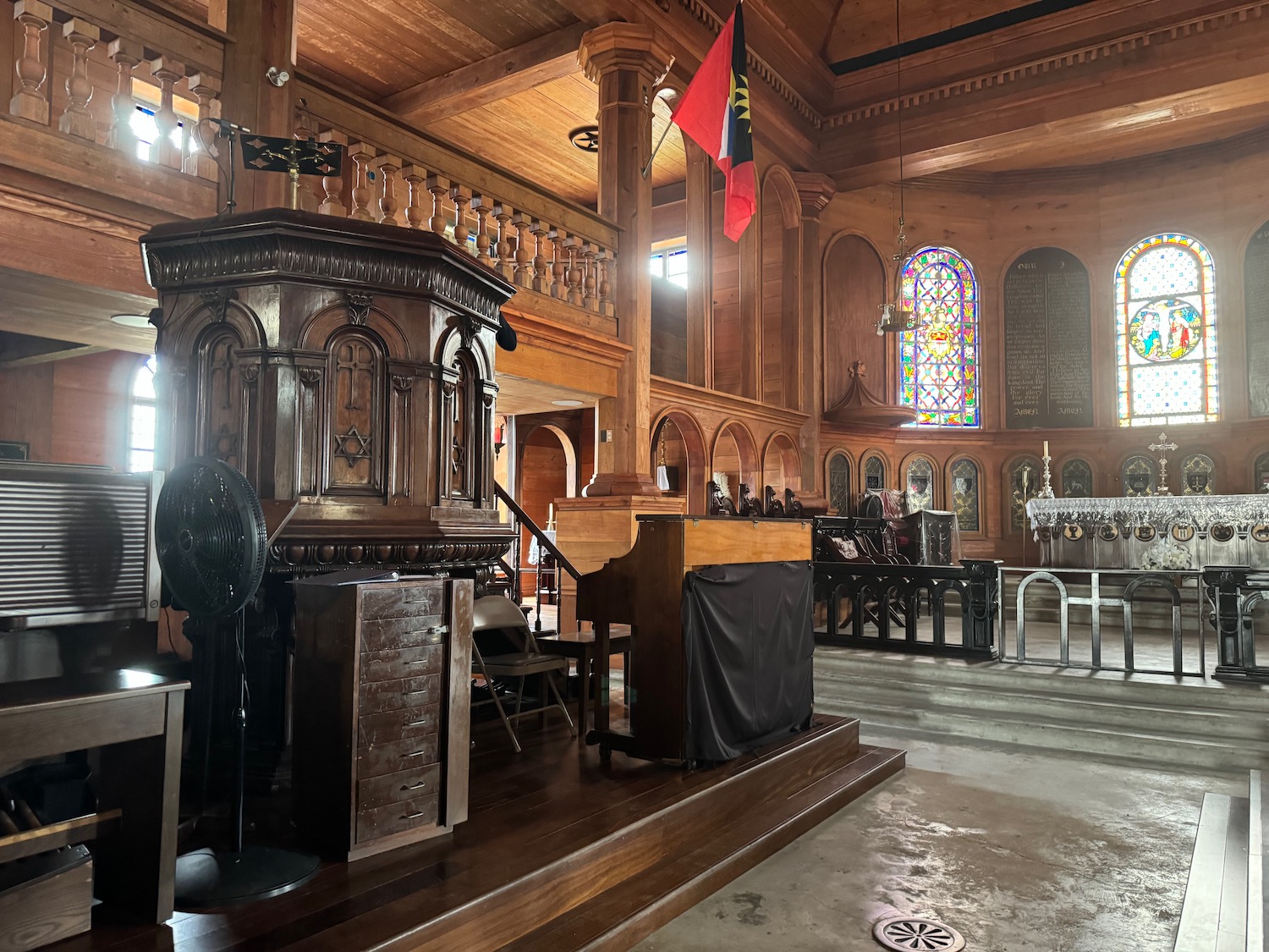 a wooden church with a podium and a flag