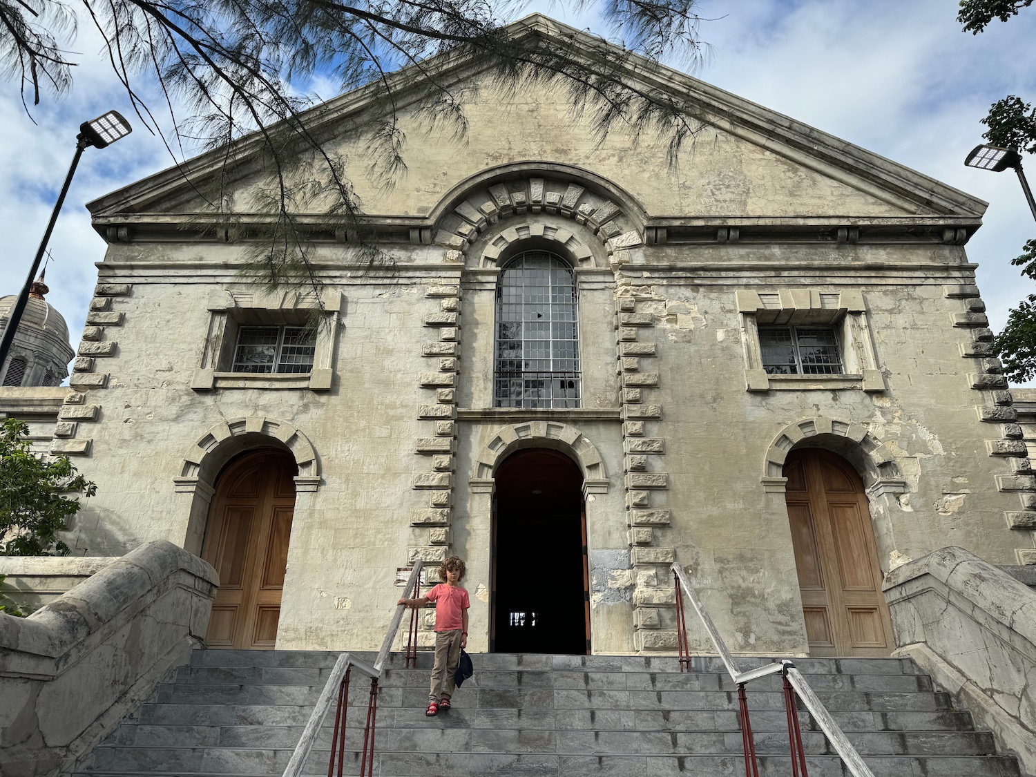 a child walking up stairs to a building