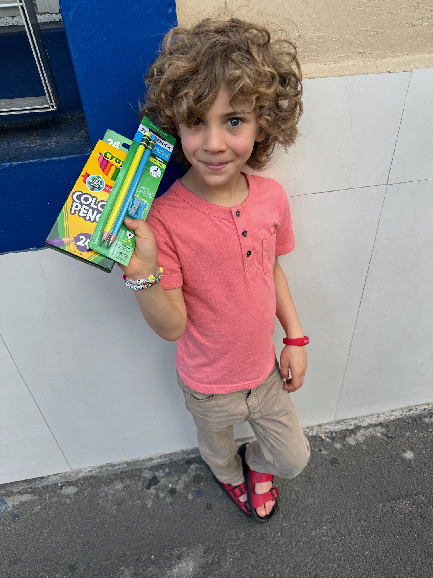 a child holding a box of pencils