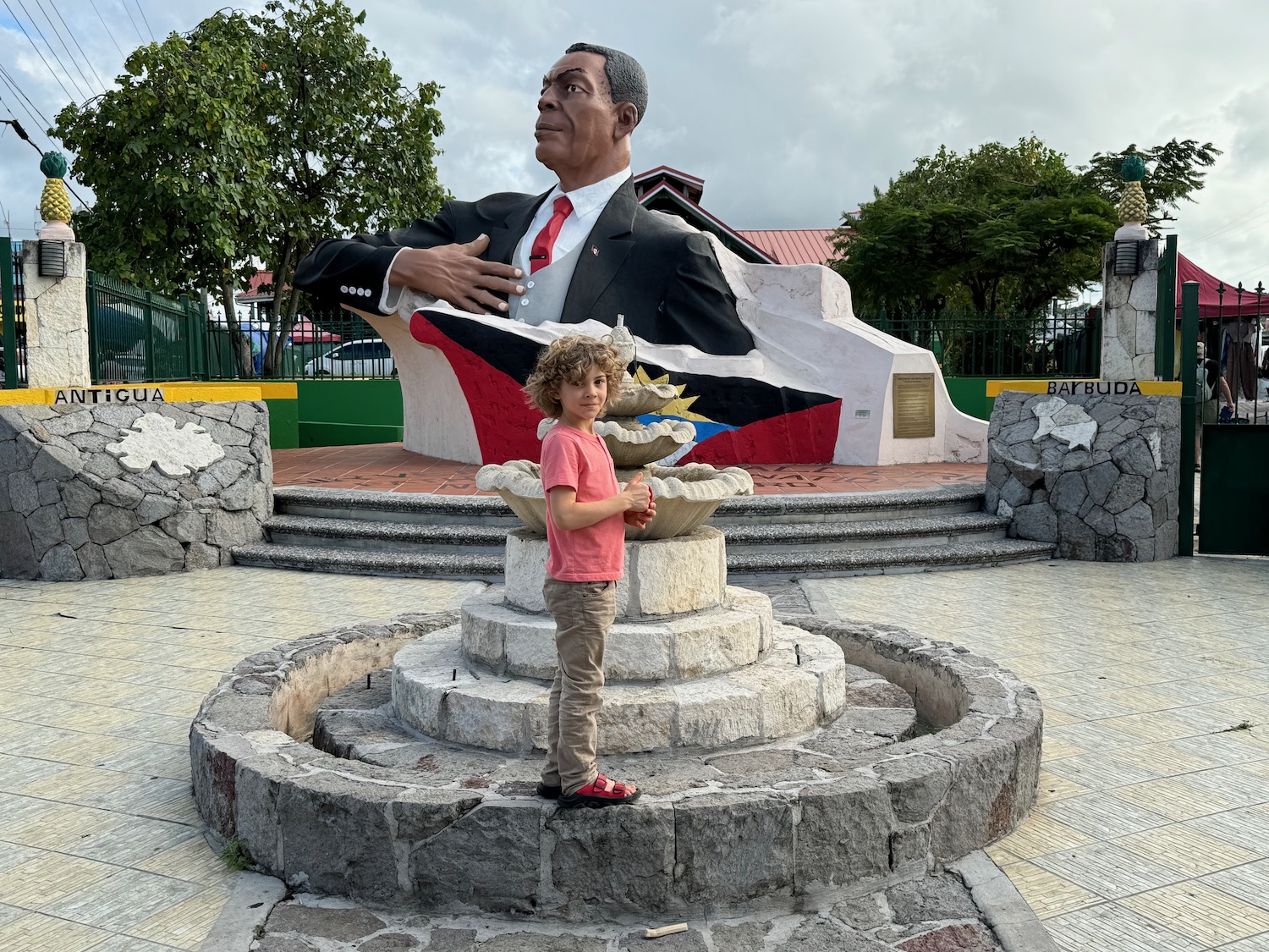 a child standing in front of a statue