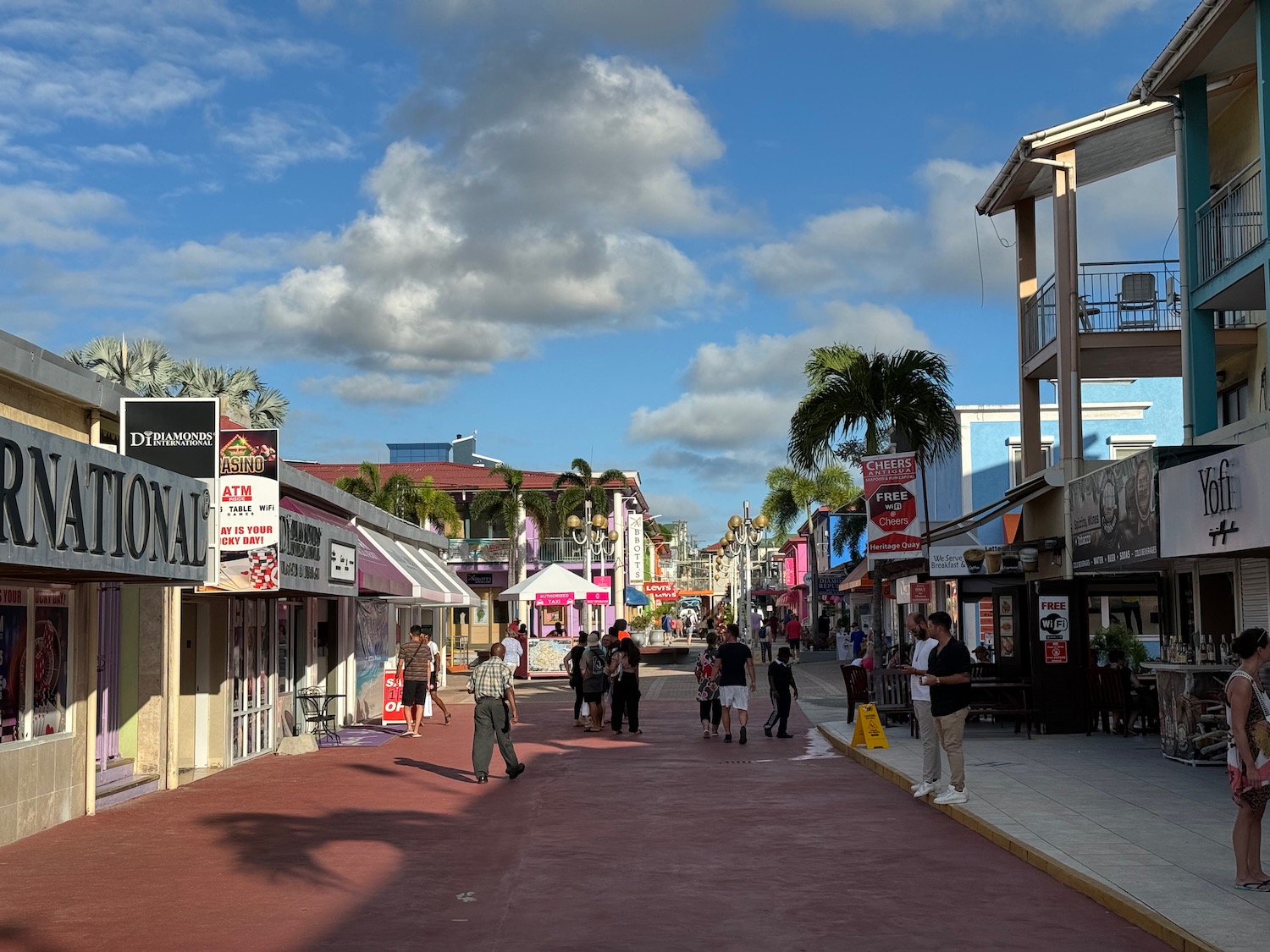 a street with shops and people walking on it