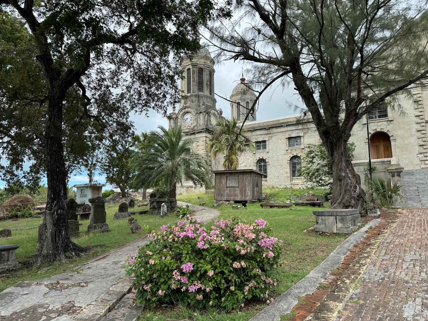 a cemetery with a clock tower and trees