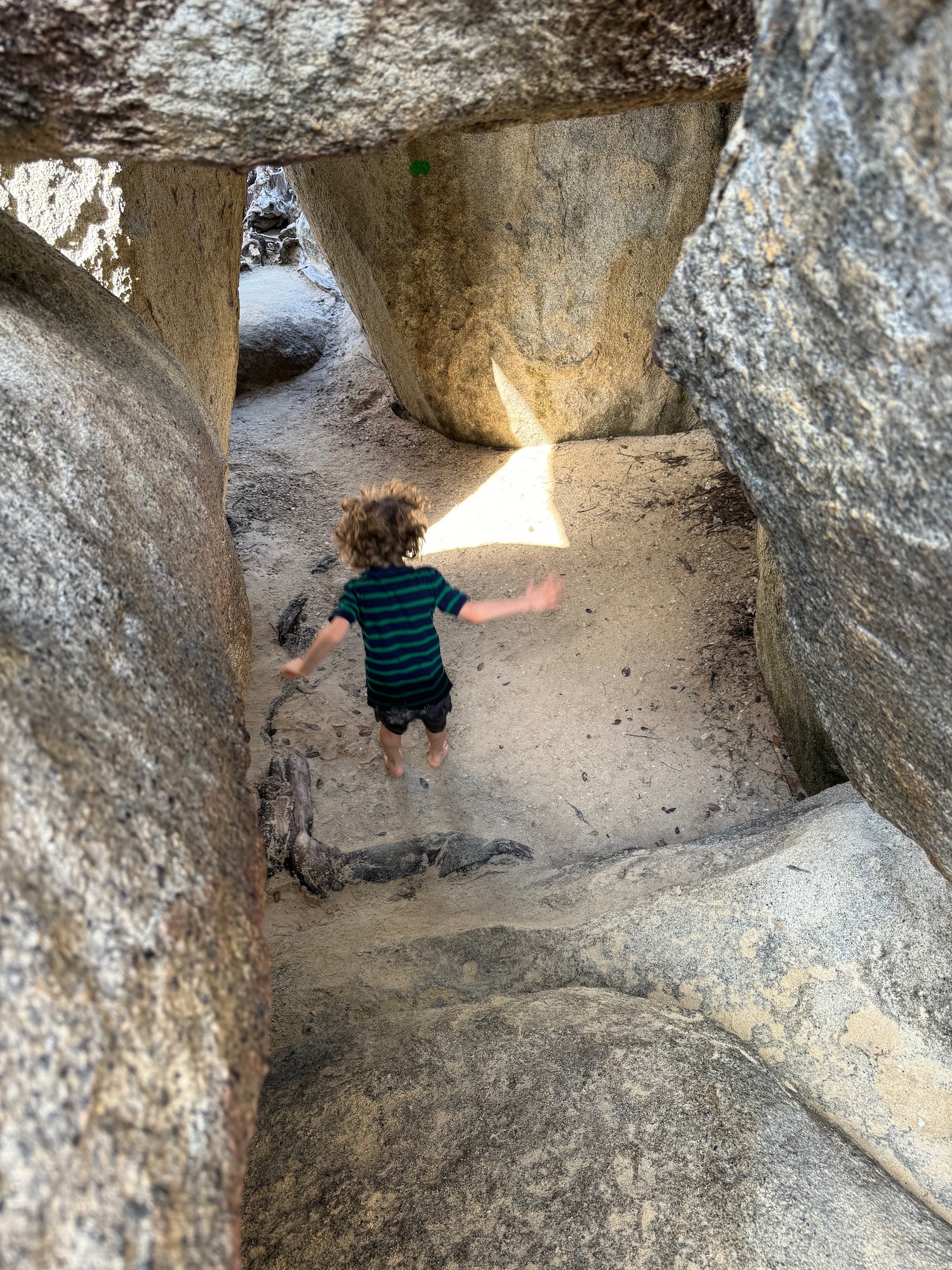 a child standing in a rock formation