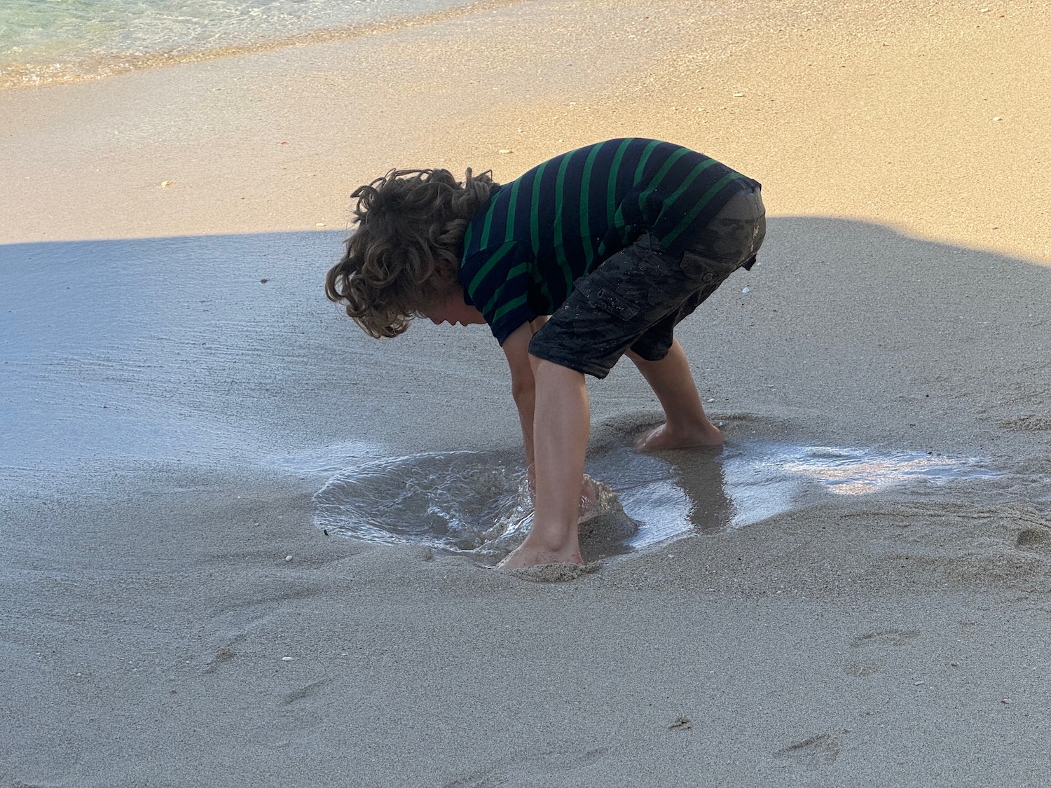 a child playing in the sand