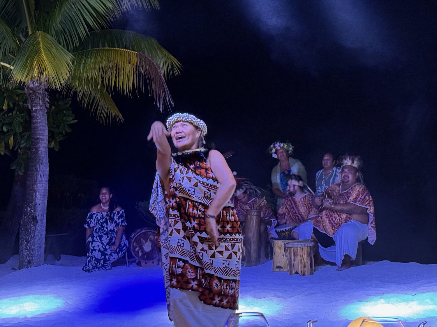 a woman in a dress dancing on a beach