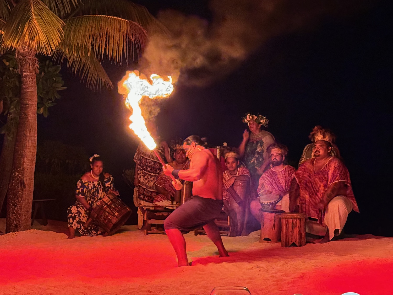 a man holding a torch with people watching