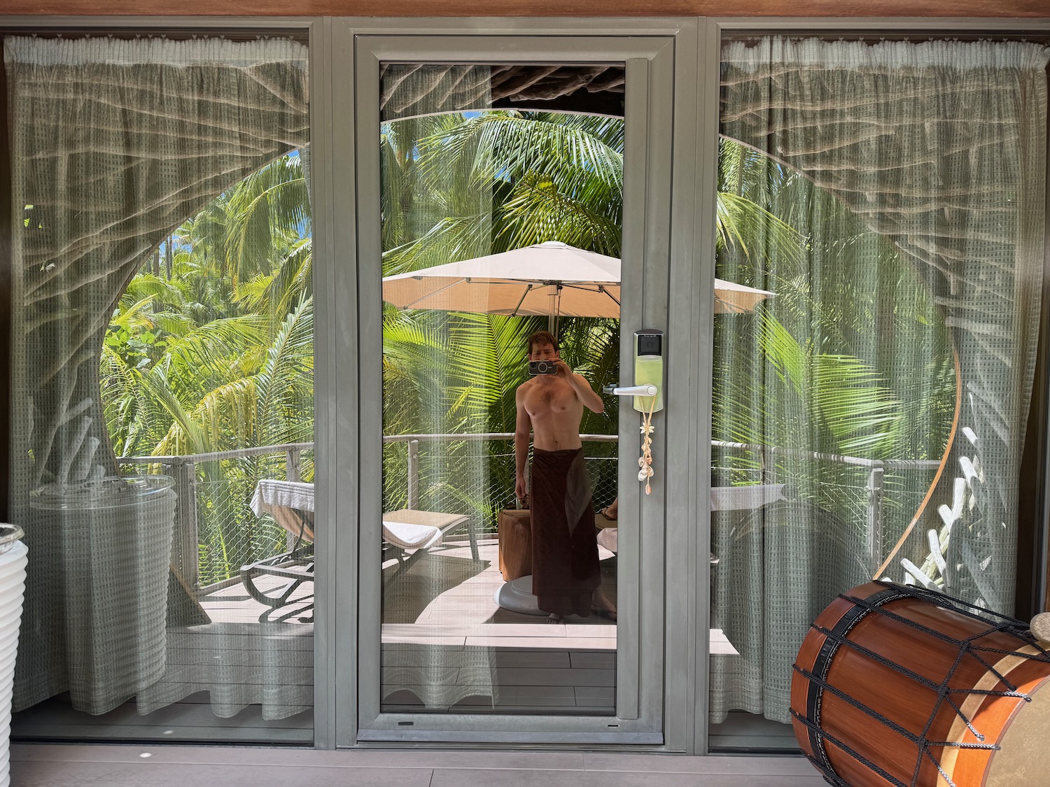 a man standing in front of a glass door