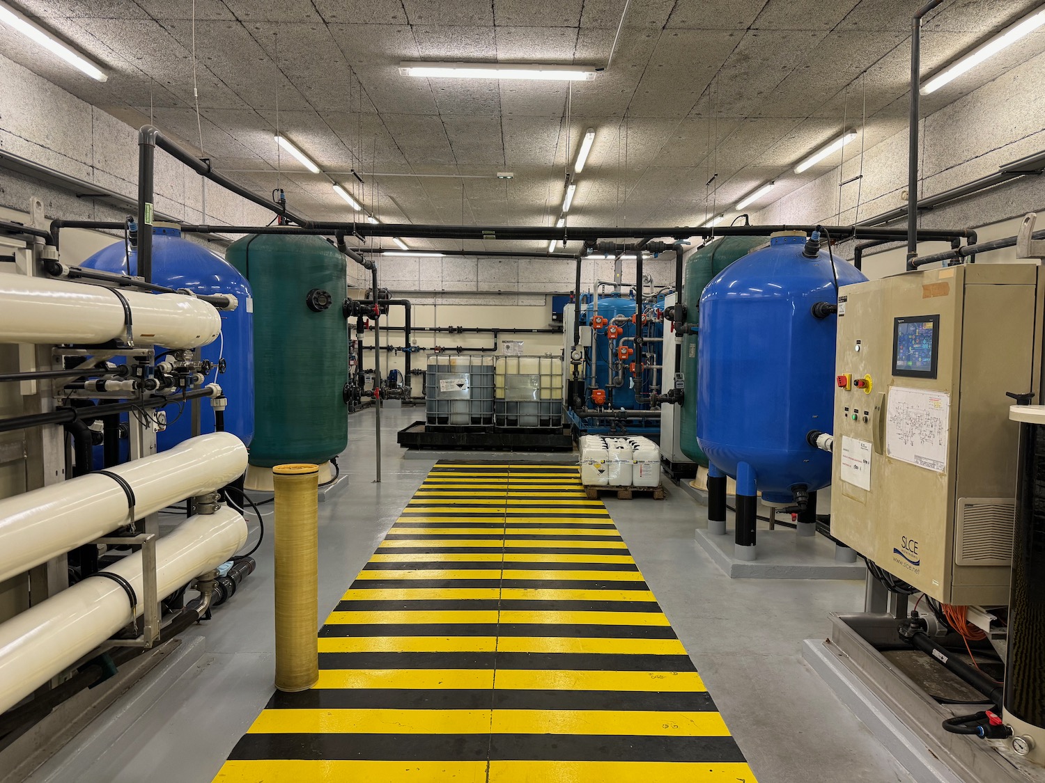 a room with large blue tanks and machines