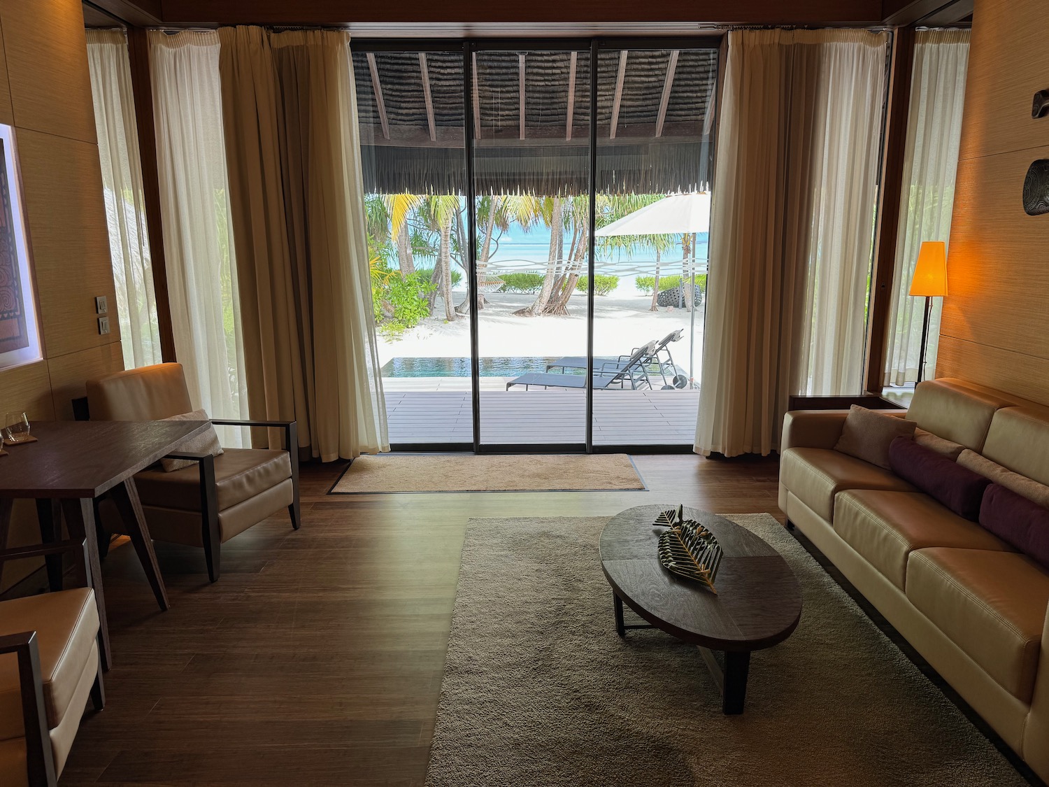 a living room with a glass door and a couch and a table