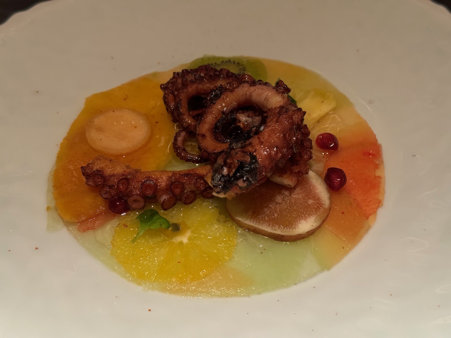 a plate of food with octopus and orange slices