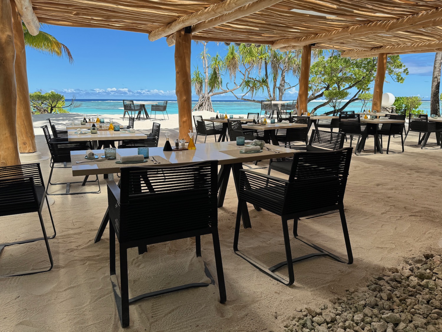 tables and chairs on a beach