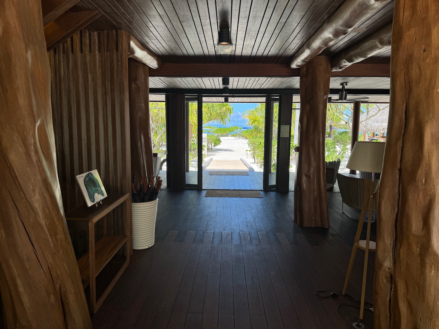 a hallway with wood beams and a wood floor