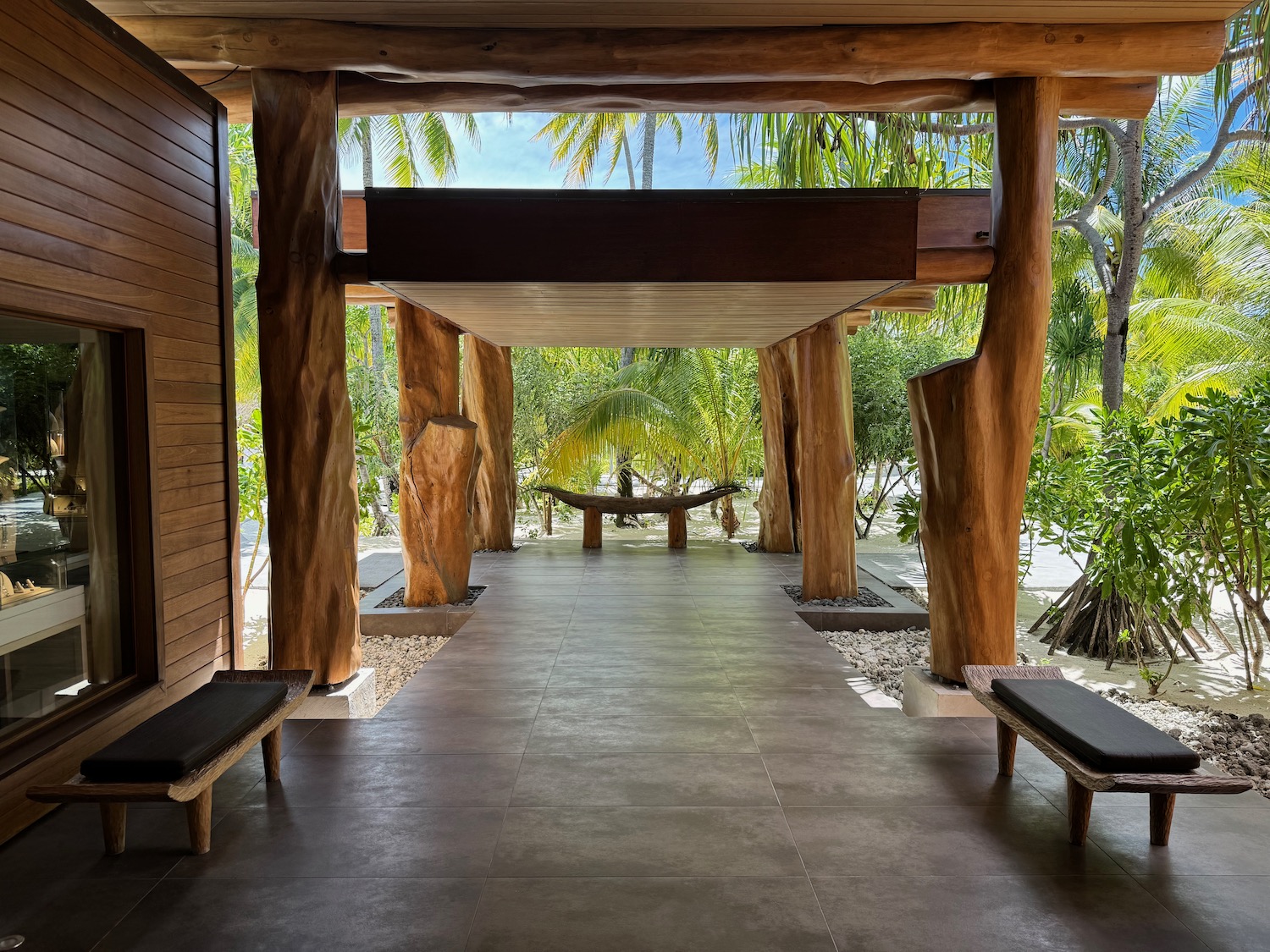 a wooden structure with benches and trees