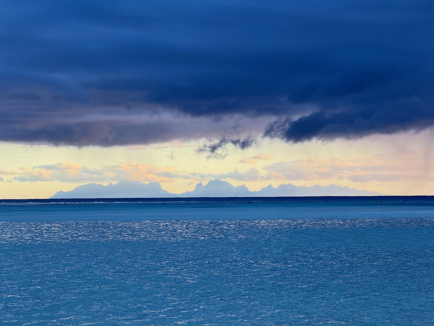 a body of water with mountains in the distance