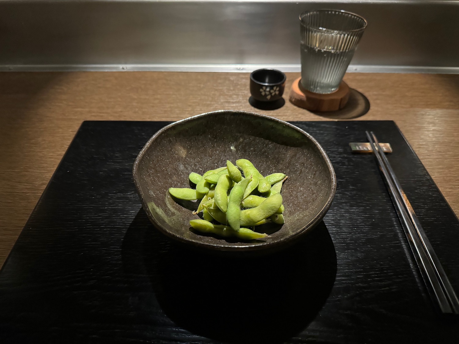 a bowl of edamame on a table