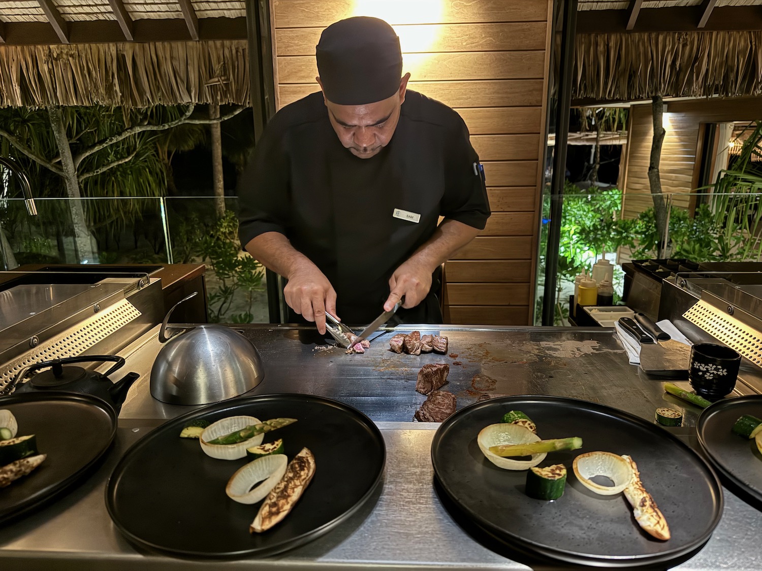 a man cooking food on a grill