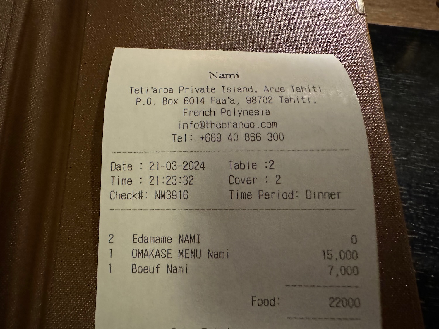 a receipt on a brown surface