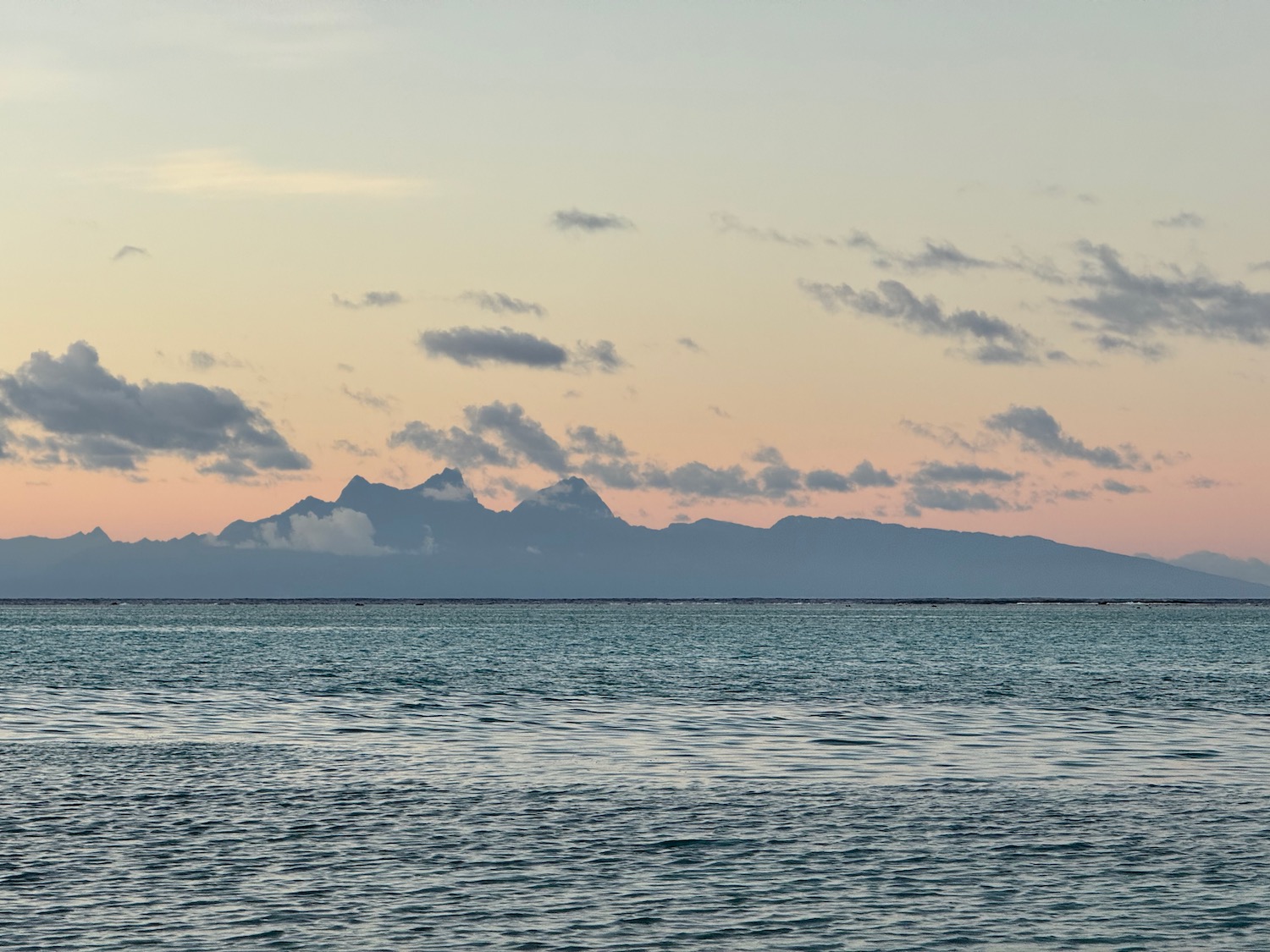 a body of water with mountains in the distance