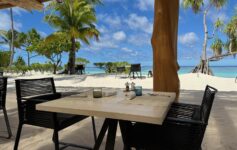 a table and chairs on a beach