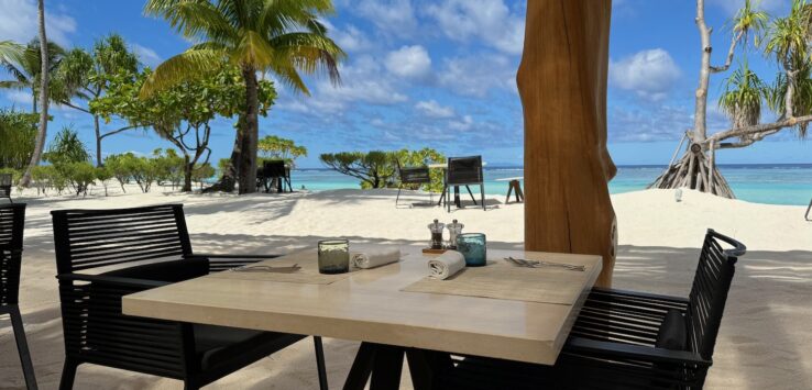 a table and chairs on a beach