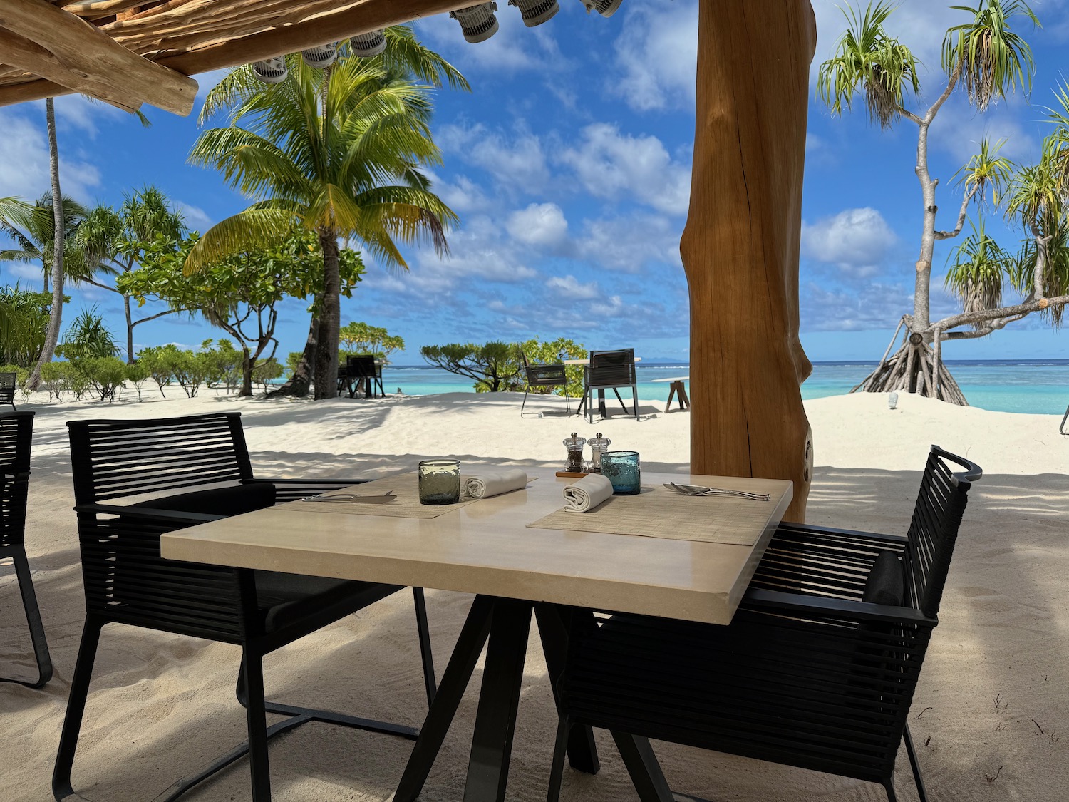 a table and chairs on a beach