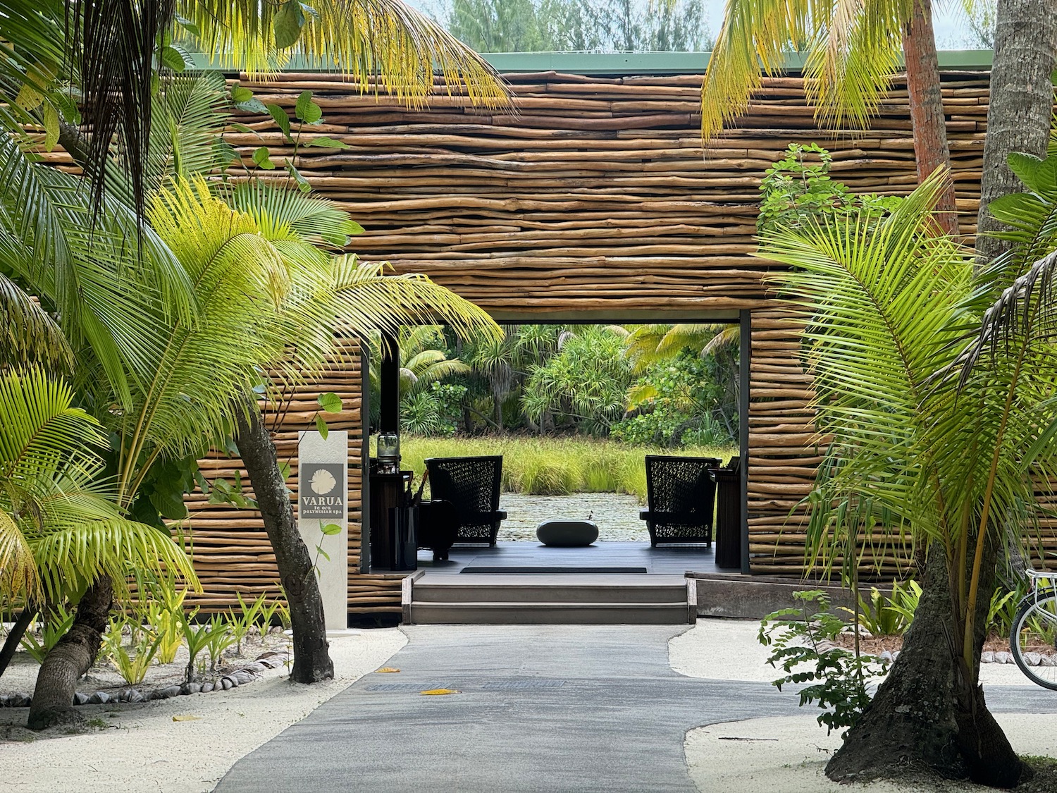 a wooden building with a pool and trees