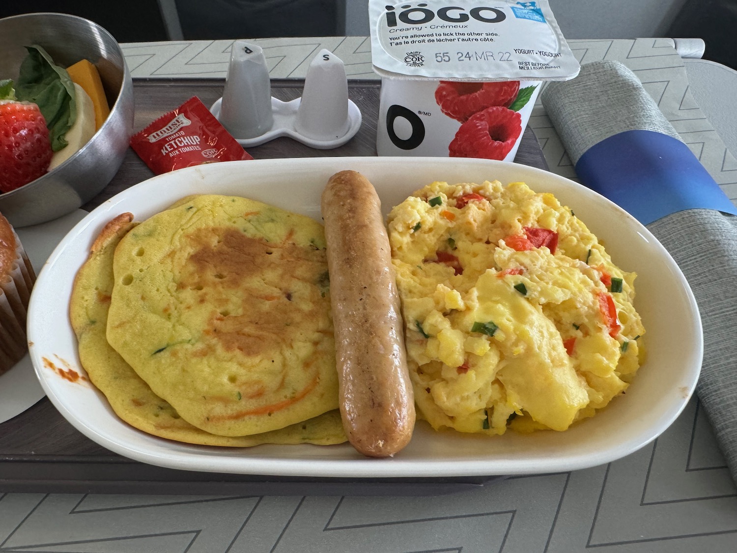 a plate of food with a sausage and eggs