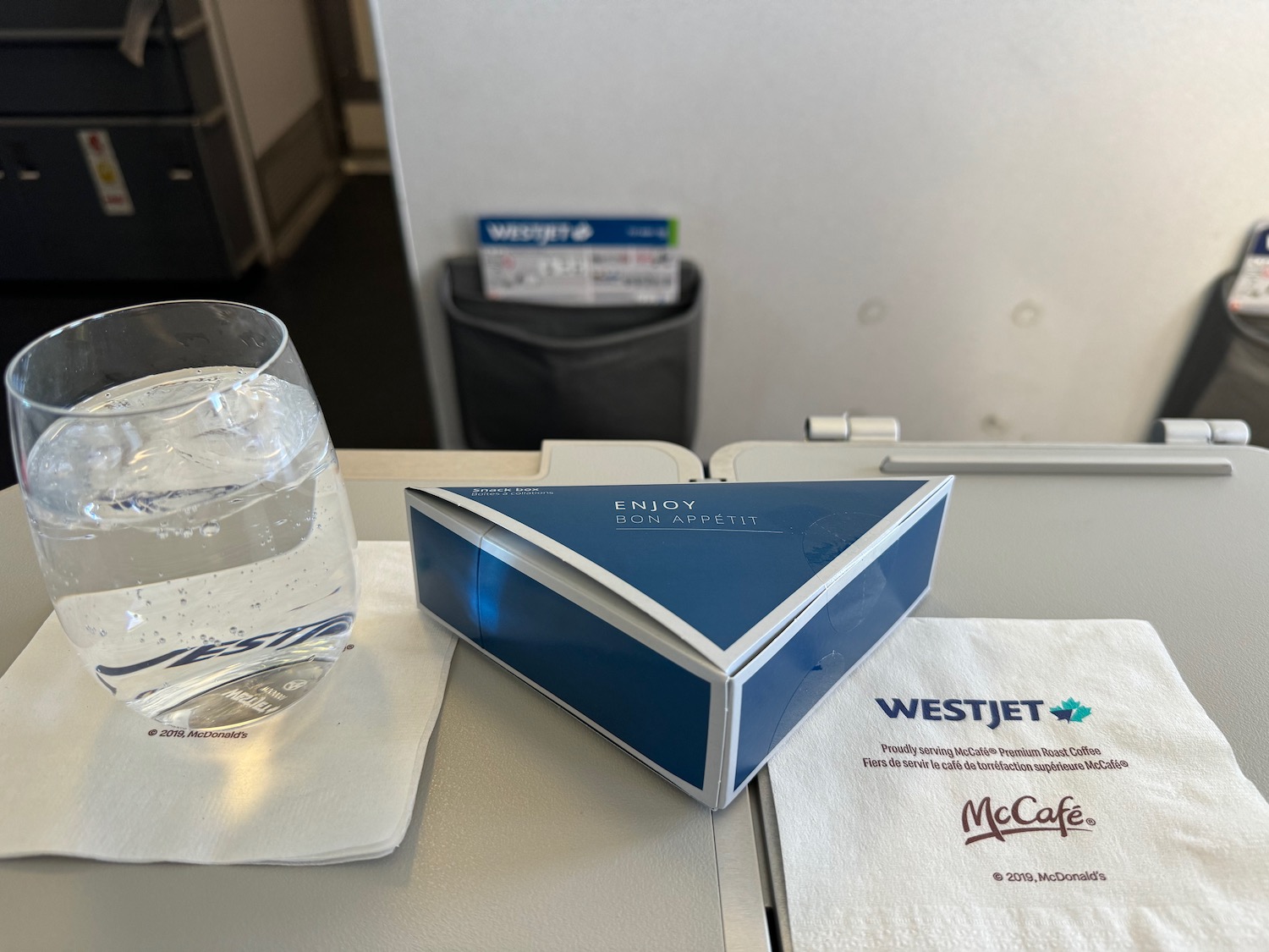 a box and a glass of water on a table