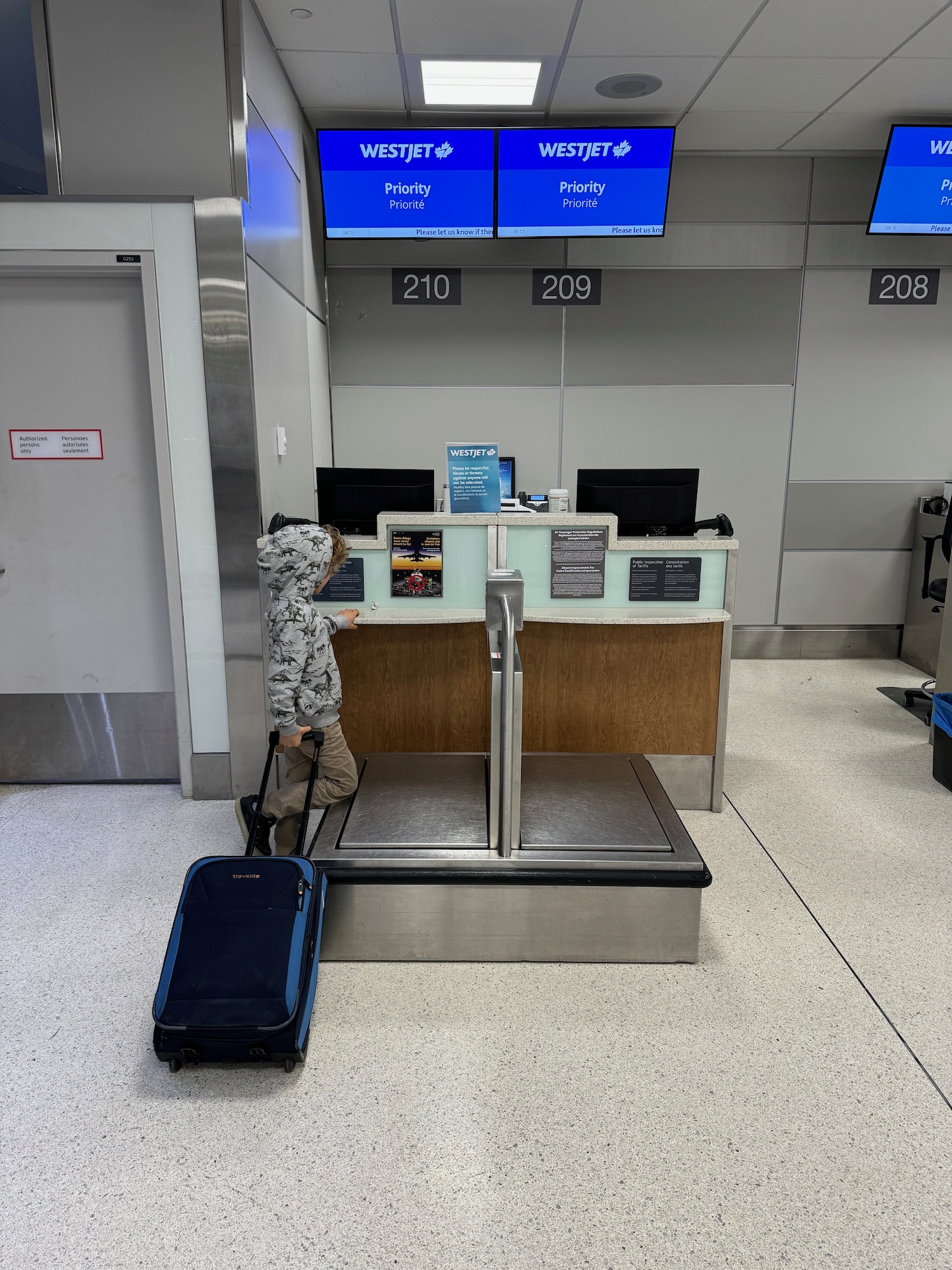 a child with a luggage bag in a airport