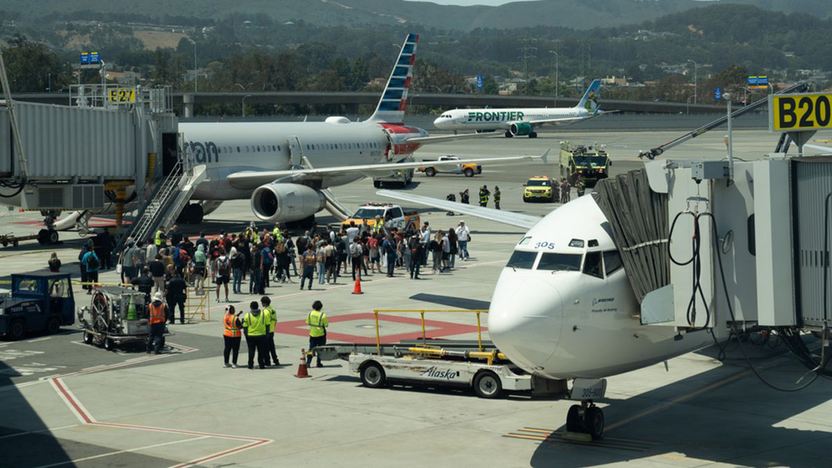 a group of people standing around an airplane