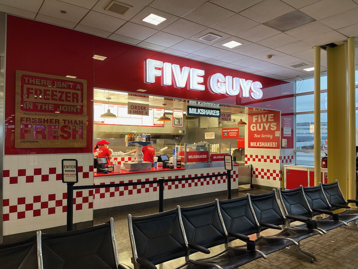 a fast food restaurant with chairs and a window