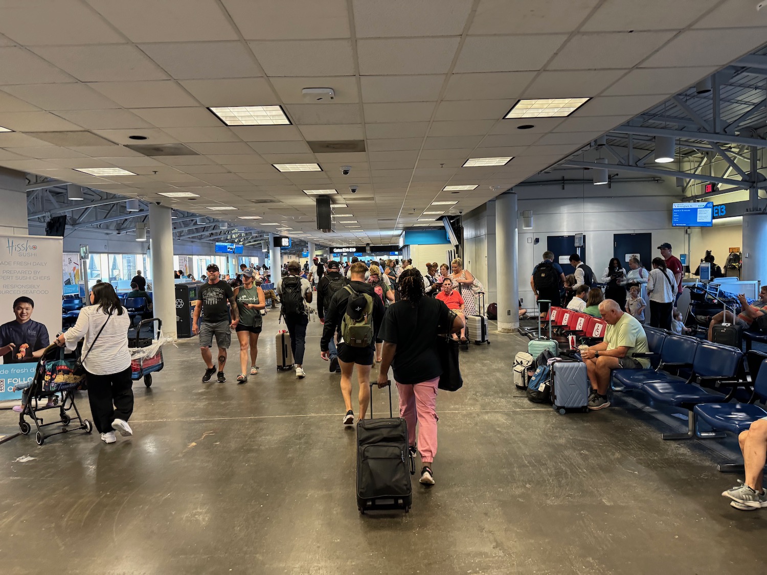 a group of people walking in an airport terminal