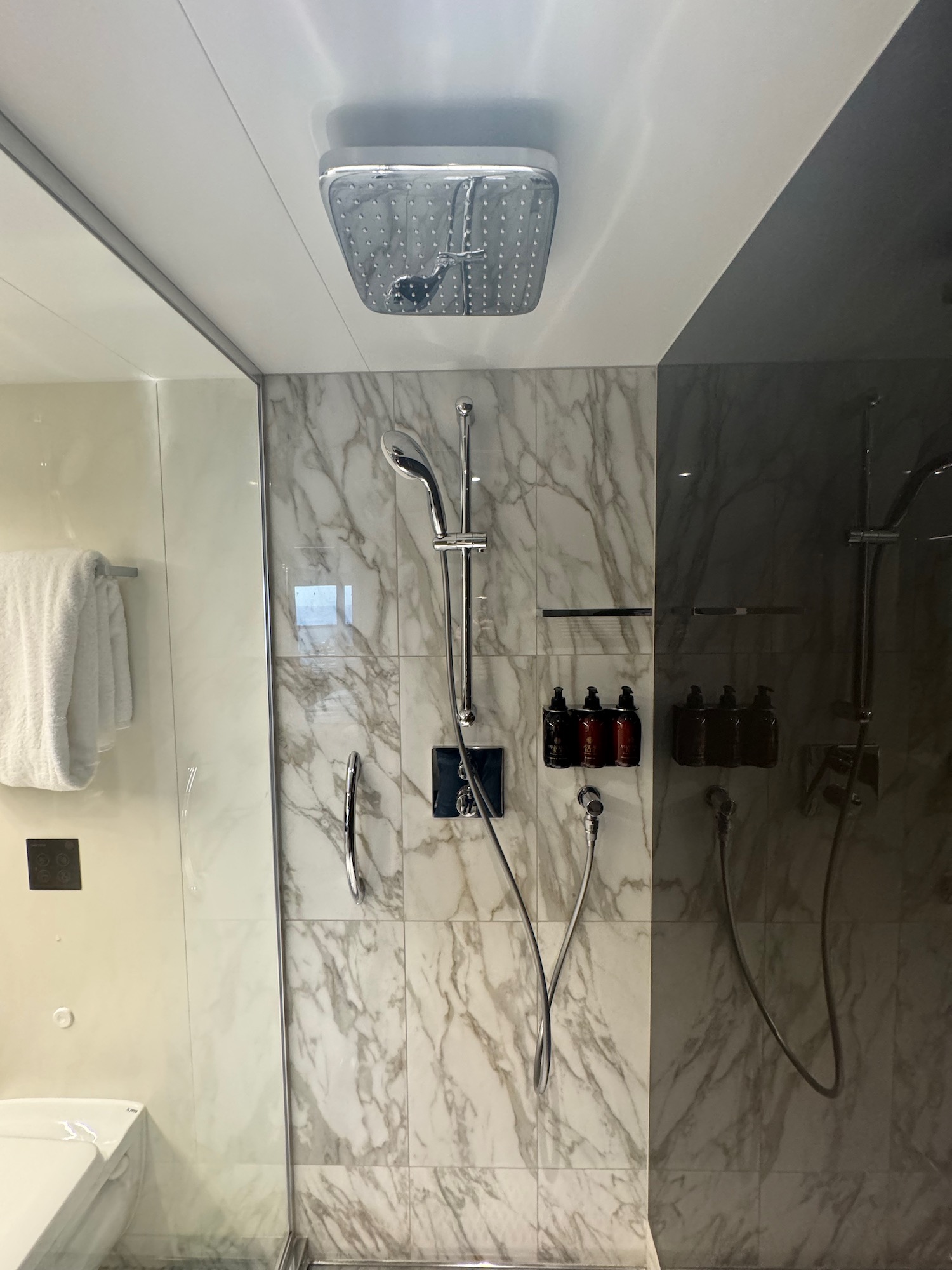 a shower with a white towel and a white towel on the ceiling