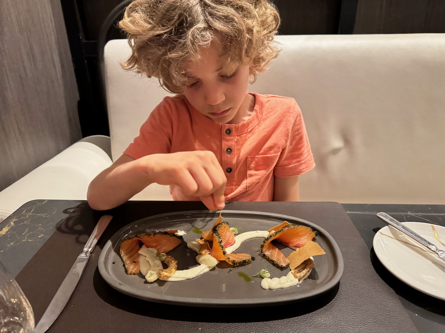 a boy eating food on a plate