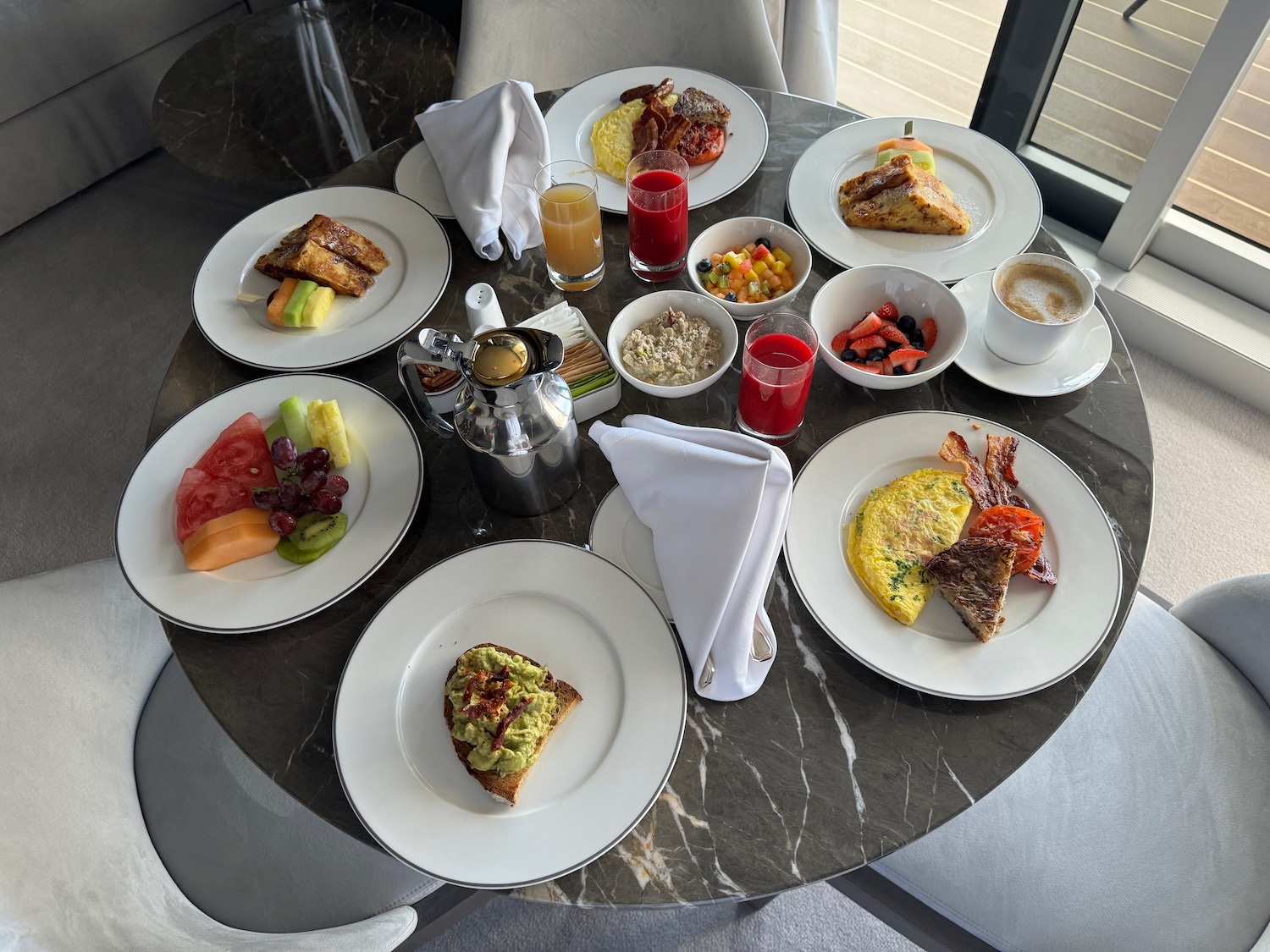 a table with plates of food and drinks